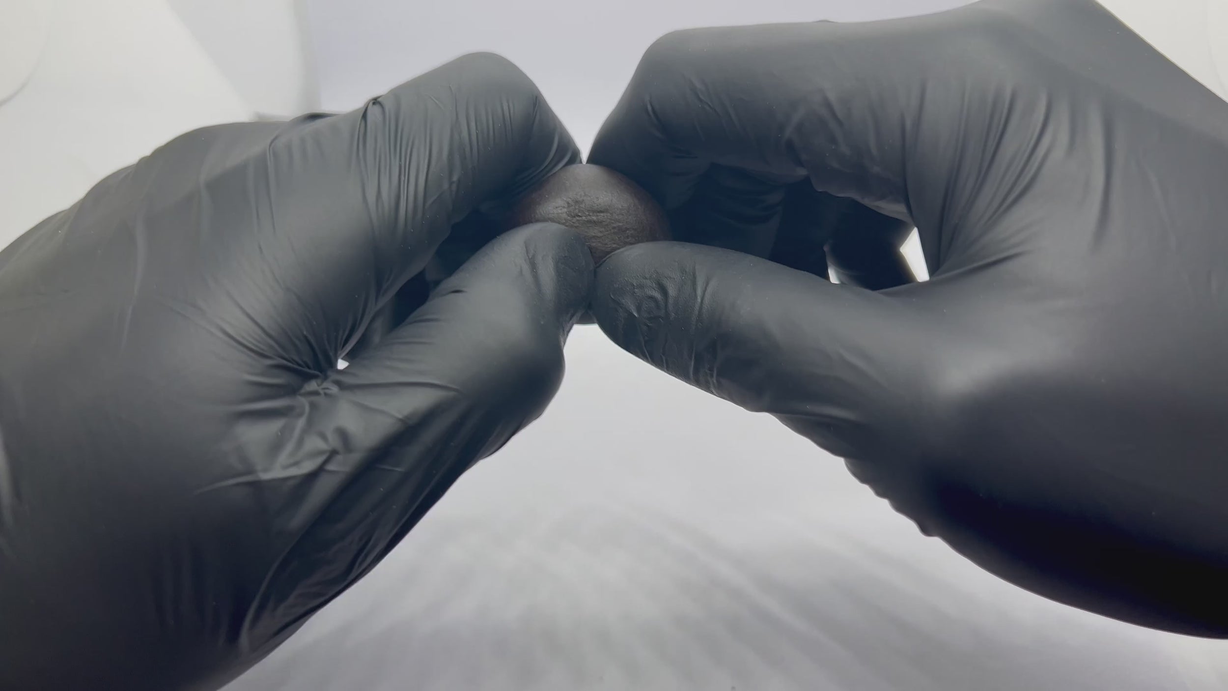 Red Lebanese CBD 5g hash ball opening up 